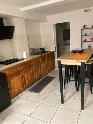 a kitchen with a wooden table in a room at Appartement à deux pas du centre ville in Limoux