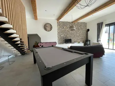 a living room with a pool table in it at Piscine privée sans vis à vis / Calme / Babyfoot in Conques-sur-Orbiel