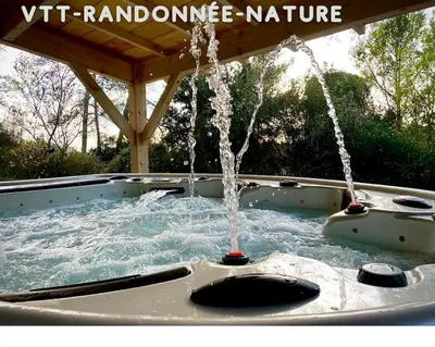a hot tub with water coming out of it at Plein cœur de la nature ~ Jacuzzi Privé 24h/24h in Ventenac-Cabardès