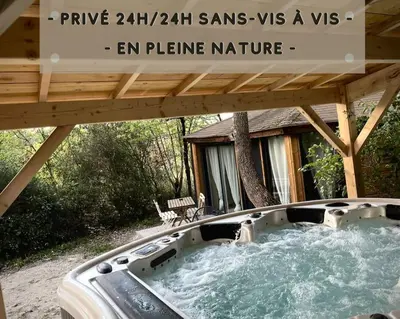 a hot tub under a pergola in a backyard at Plein cœur de la nature ~ Jacuzzi Privé 24h/24h in Ventenac-Cabardès