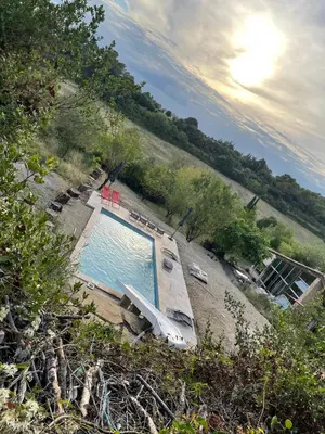 an overhead view of a swimming pool with a beach at Plein cœur de la nature ~ Jacuzzi Privé 24h/24h in Ventenac-Cabardès