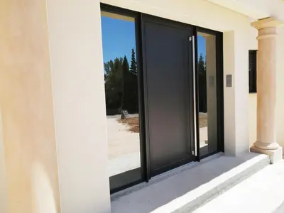 a sliding glass door on the side of a building at Trois appartements au sein du Mas Jams - Le Gouleyrous, Le Canigou et Le Figarassa in Vingrau