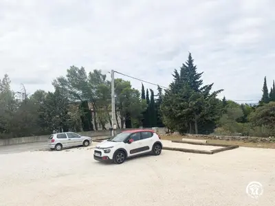 two cars are parked in a parking lot at Trois appartements au sein du Mas Jams - Le Gouleyrous, Le Canigou et Le Figarassa in Vingrau