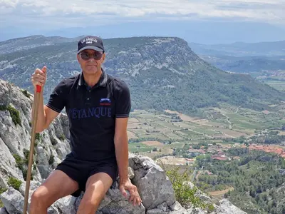 a man sitting on top of a mountain at Trois appartements au sein du Mas Jams - Le Gouleyrous, Le Canigou et Le Figarassa in Vingrau