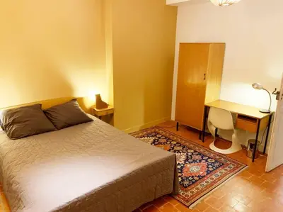 a bedroom with a bed and a desk and a desk at La Grande Traverse gîte d'exception de bord de mer in Lapalme