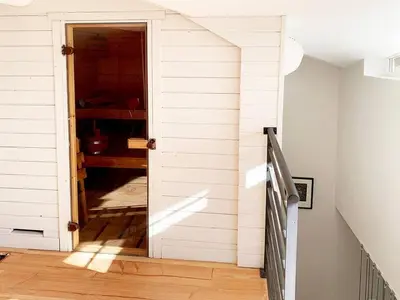 an open door to a room with white walls at La Grande Traverse gîte d'exception de bord de mer in Lapalme