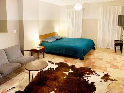 a living room with a bed and a couch at La Grande Traverse gîte d'exception de bord de mer in Lapalme