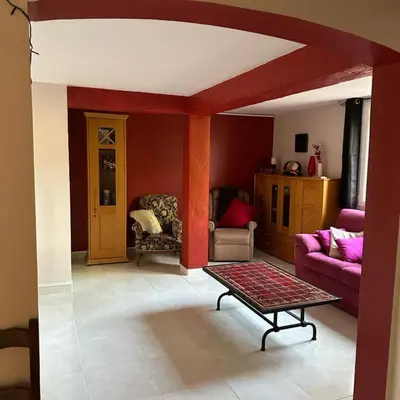 a living room with a couch and a table at Ty Calon Lan in Montazels