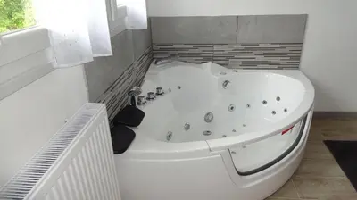 a white bath tub in a bathroom with a window at Ty Calon Lan in Montazels
