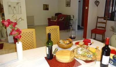 a table with two bottles of wine and food on it at Ty Calon Lan in Montazels