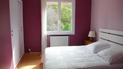 a bedroom with a white bed and a window at Ty Calon Lan in Montazels