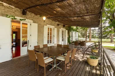 a wooden deck with a table and chairs on a house at L'HORTE in Revel