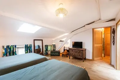 a bedroom with two beds and a television at L'HORTE in Revel