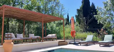 a patio with an umbrella and a swimming pool at Villa st Francois Heated swimming pool ,air conditioning ,free parking in Carcassonne