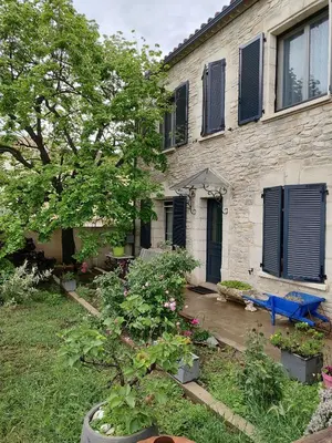a house with a blue bench in front of it at Gîte et Chambre d'hôte Entre Tilleul et Agrumes in Vinassan