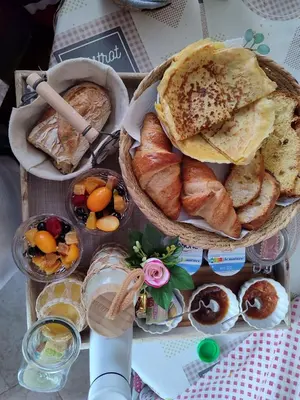 a table topped with baskets of bread and other foods at Gîte et Chambre d'hôte Entre Tilleul et Agrumes in Vinassan