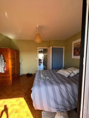 a bedroom with a large bed in a room at Chez Armelle in Port-la-Nouvelle
