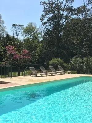 a swimming pool with lounge chairs in a yard at Château Pech-Celeyran in Salles-dʼAude