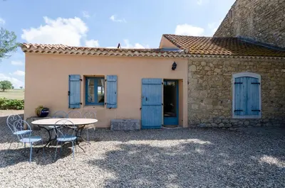 a table and chairs in front of a house at Château Pech-Celeyran in Salles-dʼAude