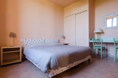a bedroom with a bed and a table and a desk at Château Pech-Celeyran in Salles-dʼAude