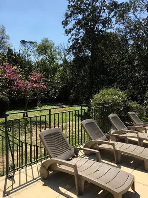 a group of chairs sitting on a deck at Château Pech-Celeyran in Salles-dʼAude