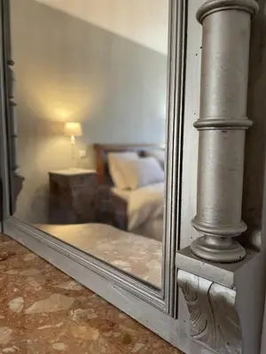 a mirror reflection of a living room with a couch at Le Taurillou in Taurize