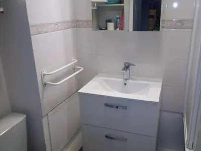 a white bathroom with a sink and a tub at Studio cabine avec piscine et vue port à Gruissan - FR-1-409-199 in Gruissan