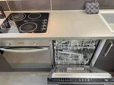 a dish rack in a dishwasher in a kitchen at L'Évêché - T3 Spacieux & Traversant en Hypercentre in Castres