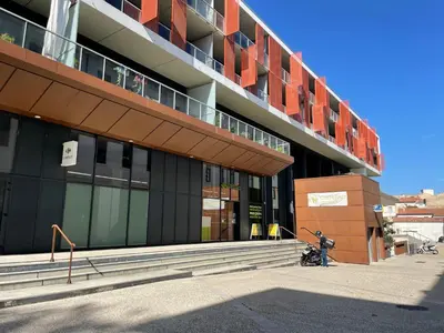 a building with a motorcycle parked in front of it at L'Évêché - T3 Spacieux & Traversant en Hypercentre in Castres