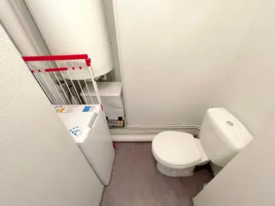 a small bathroom with a toilet and a sink at L'Évêché - T3 Spacieux & Traversant en Hypercentre in Castres