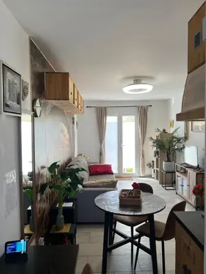 a living room with a couch and a table at Le CLOS du LÉZARD - L'escapade in Port-la-Nouvelle
