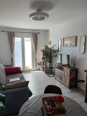 a living room with a couch and a tv at Le CLOS du LÉZARD - L'escapade in Port-la-Nouvelle