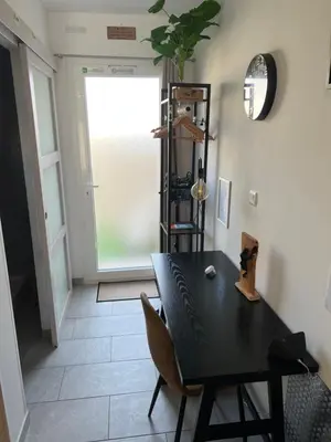 a dining room with a black table and a window at Le CLOS du LÉZARD - L'escapade in Port-la-Nouvelle