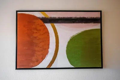 a framed painting on a wall at Logis des Goélands YourHostHelper in Gruissan