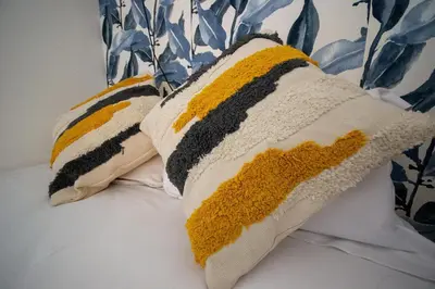 two pillows sitting on top of a bed at Logis des Goélands YourHostHelper in Gruissan