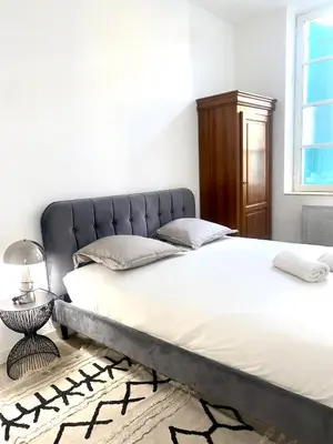 a bedroom with a large bed with a metal headboard at *Chic & Basic T3* place Carnot in Carcassonne