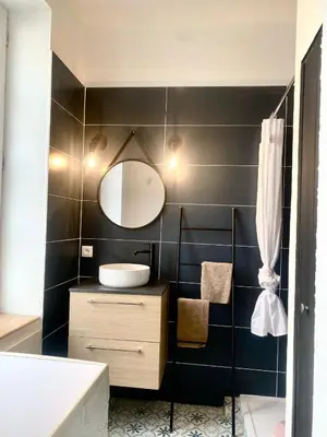 a bathroom with a sink and a mirror at *Chic & Basic T3* place Carnot in Carcassonne