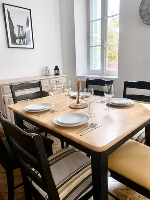 a wooden table with glasses and plates on it at *Chic & Basic T3* place Carnot in Carcassonne