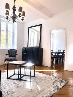 a living room with a table and a tv at *Chic & Basic T3* place Carnot in Carcassonne