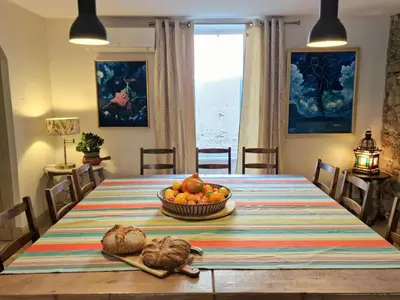 a dining room table with a bowl of fruit on it at L'Orée de la cité in Carcassonne