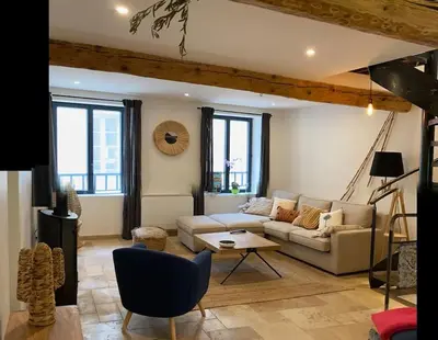 a living room with a couch and a table at Maison Marceau Gruissan in Gruissan