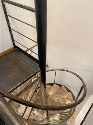 a metal chair sitting on top of a staircase at Maison Marceau Gruissan in Gruissan