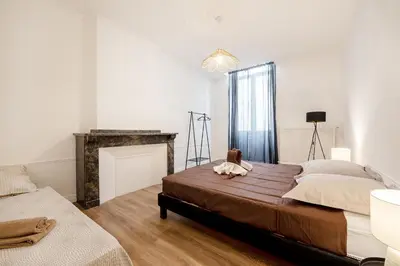 a bedroom with a bed with a stuffed animal on it at Le Louis XVI - Majestueux Appart Centre Ville in Carcassonne