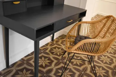a black desk with a rattan chair and a black table at Le Louis XVI - Majestueux Appart Centre Ville in Carcassonne