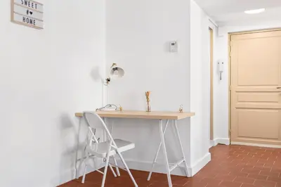 a desk in a room with a chair and a door at Les Colonnes - T3 - Bastide in Carcassonne