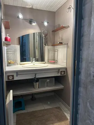 a bathroom with a sink and a mirror at la maison des lauriers rouges in Peyriac-de-Mer