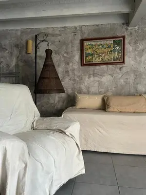 a bedroom with two beds and a painting on the wall at la maison des lauriers rouges in Peyriac-de-Mer