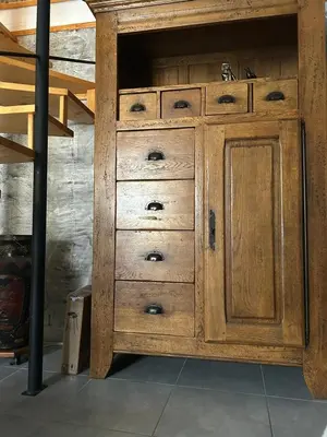 a wooden cabinet with drawers in a room at la maison des lauriers rouges in Peyriac-de-Mer