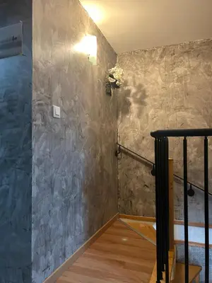 a stairway with a stone wall and a stair case at la maison des lauriers rouges in Peyriac-de-Mer