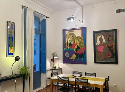 a living room with a chair and a fireplace at La Suite de la Cathédrale in Narbonne